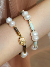 wearing blue imperial stone beaded bracelet and tiger’s eye beaded bracelet